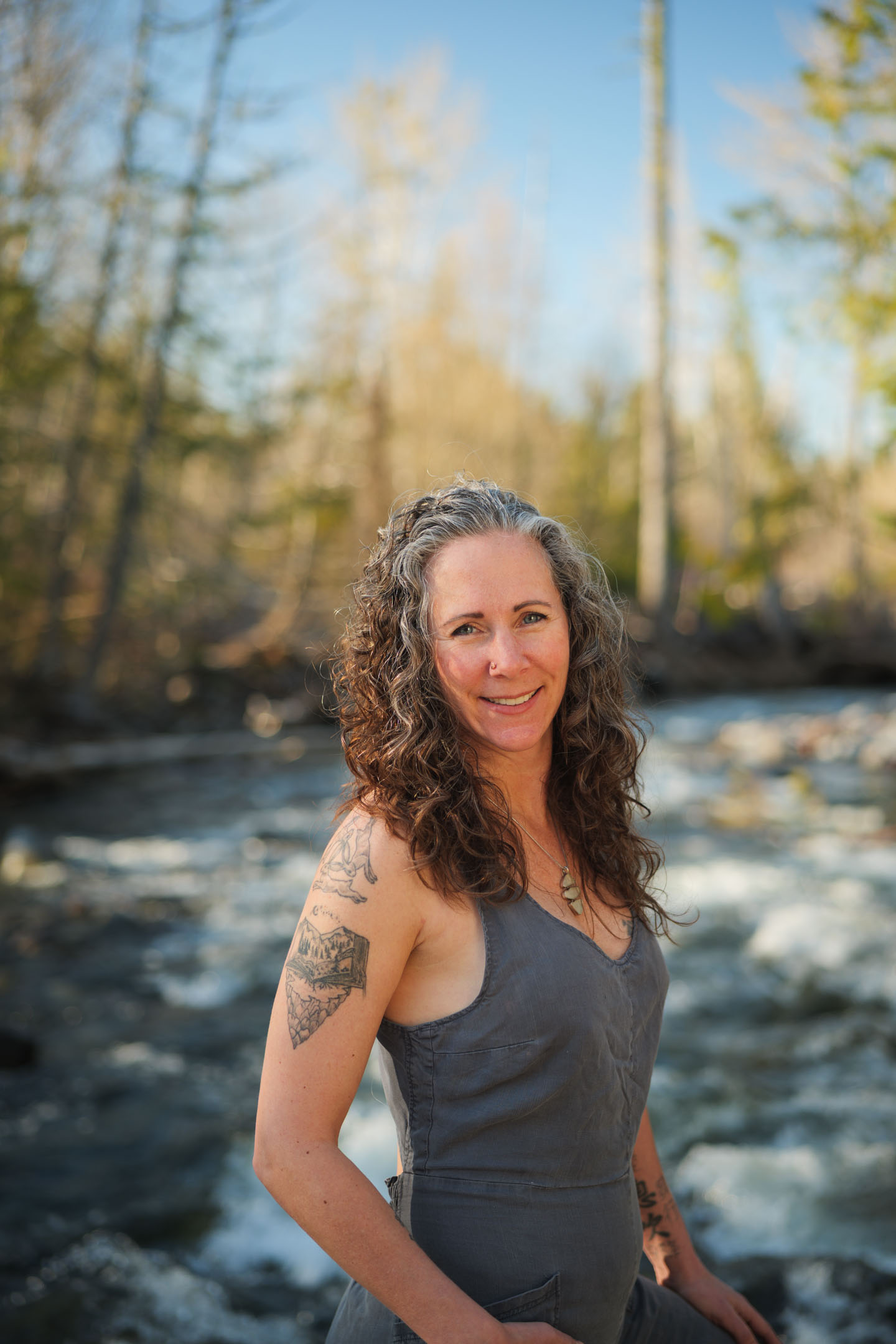 Kate Ensor smiling beside a rushing river